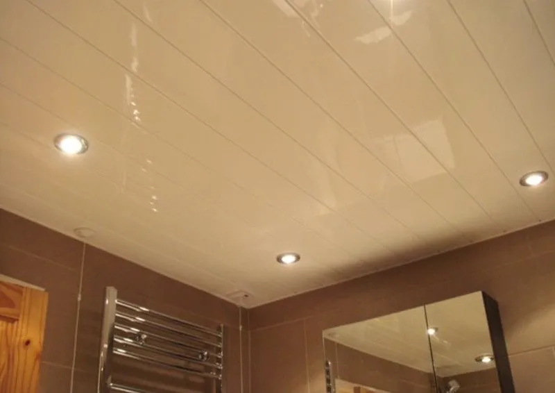 Глянцевая поверхность пластикового потолка в ванной комнате